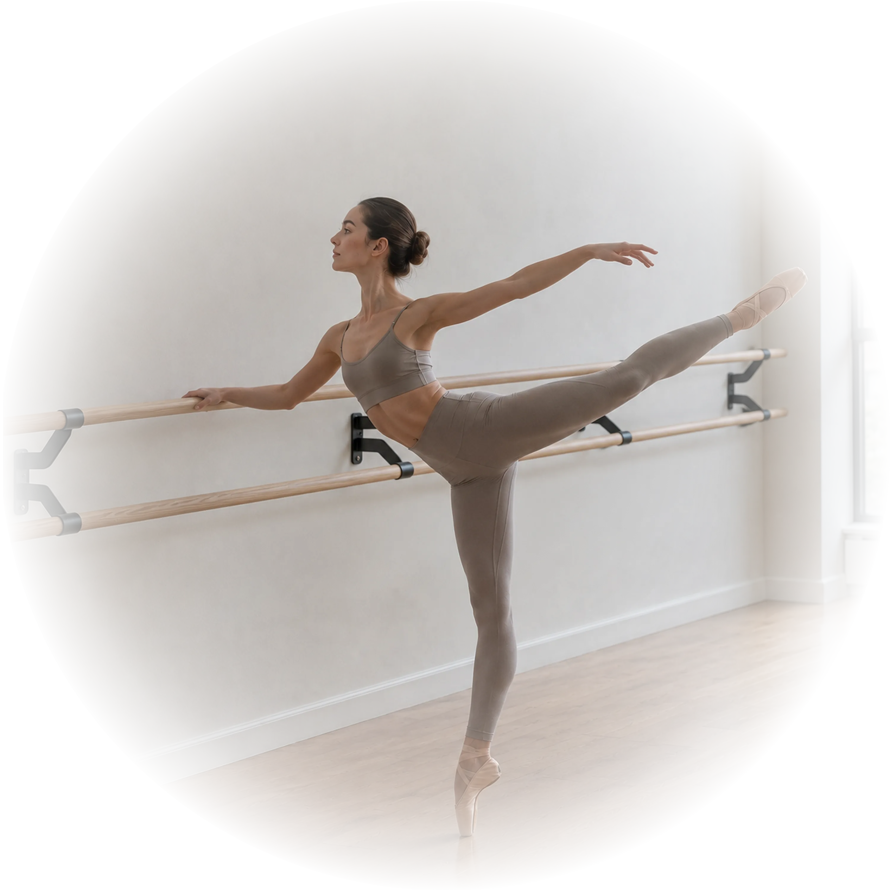 dancer using a double wall-mounted wood ballet barre